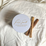'Palo Santo' candle on a white fabric background