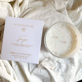 Candle and packaging on a textured white fabric background